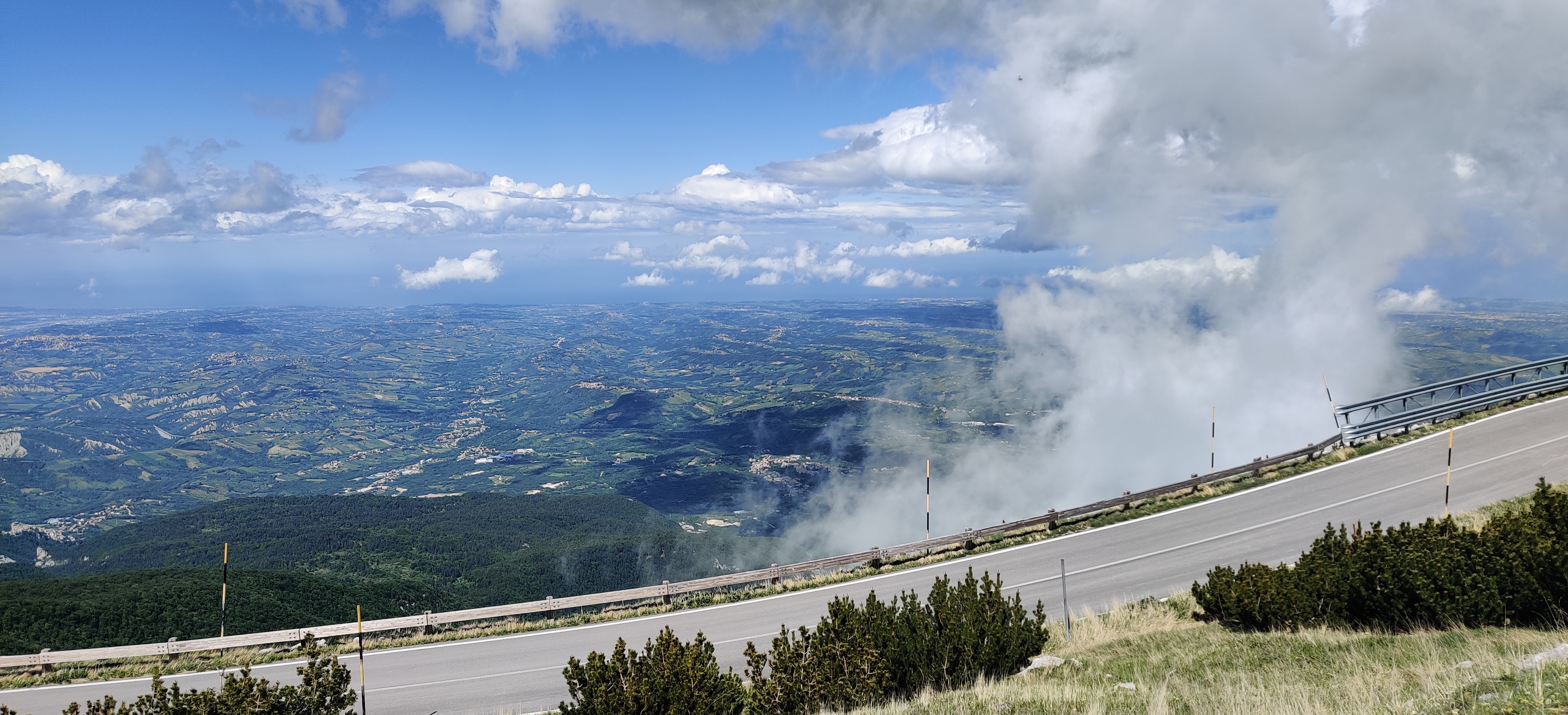 View from Col de Blockhaus into the valley below with thin clouds partially blocking the right part of the picture.